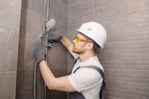 Worker installing shower system